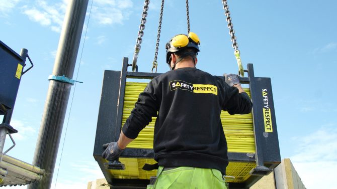 Bild på SafetyRespect-medarbetare som hanterar en leverans av fallskydd.